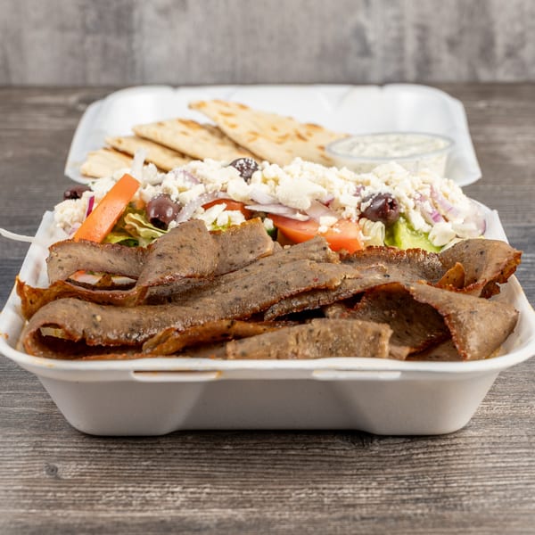 Tony's Gyros Greek Cuisine's gyro meat platter with salad, feta, olives, and pita bread.